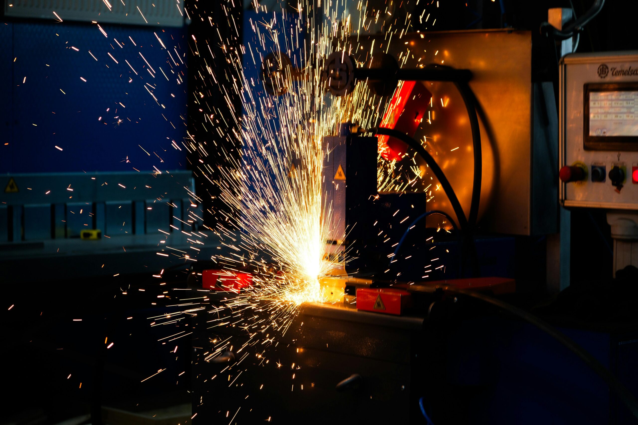 Vibrant display of welding sparks in an industrial setting, highlighting manufacturing processes.